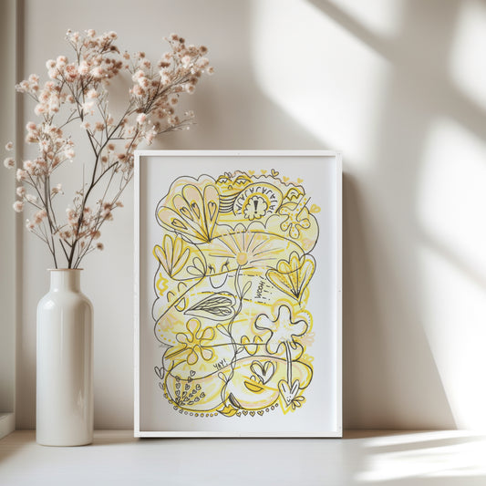 Framed yellow floral artwork on a white surface with a vase of dried flowers.