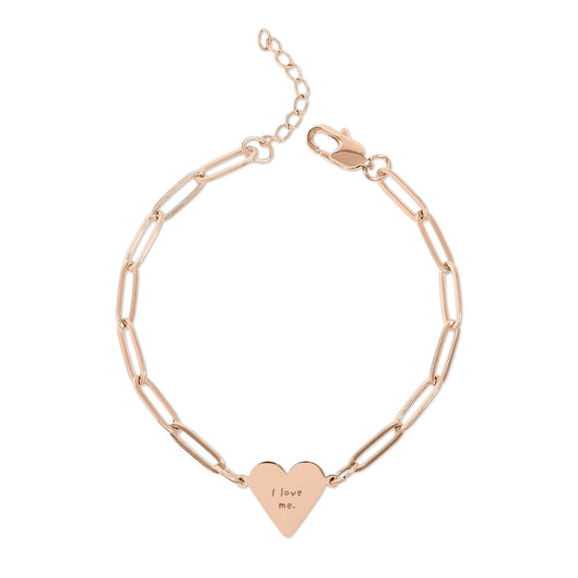 Rose gold bracelet with a heart-shaped tag "I love me." on a white background