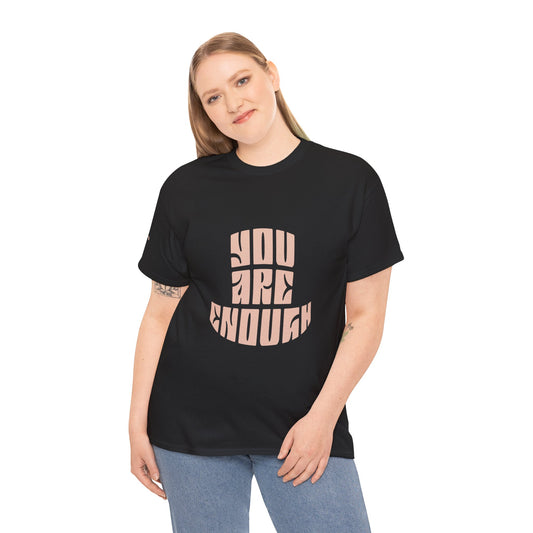 Person wearing a black t-shirt with 'YOU ARE ENOUGH' text on a black background